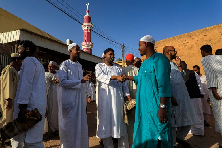 Muslim worshippers greet each other after prayers on the first day of Eid al-Fitr, which marks the end of the holy fasting month of Ramadan, at al-Hara al-Rabaa Mosque in the Juraif Gharb neighbourhood of Khartoum on April 21, 2023. (Photo by - / AFP)