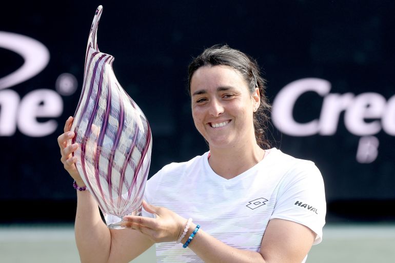 CHARLESTON, SOUTH CAROLINA - APRIL 09: Ons Jabeur of Tunisia poses with the trophy after defeating Belinda Bencic of Switzerland during the Finals of the Credit One Charleston Open at Credit One Stadium on April 09, 2023 in Charleston, South Carolina. (Photo by Matthew Stockman/Getty Images)