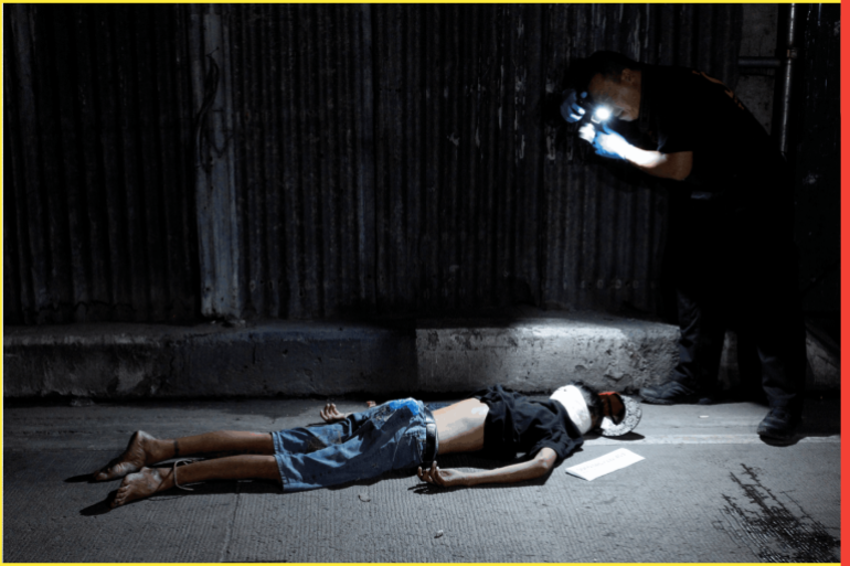ATTENTION EDITORS - VISUAL COVERAGE OF SCENCES OF INJURY AND DEATHA police investigator takes pictures of the body of a man, with his head wrapped in masking tape, found along a street in Pasay city, Metro Manila, Philippines November 10, 2016. According to police, a sachet of crystal meth known locally as "shabu" was recovered from the body. REUTERS/Czar Dancel TEMPLATE OUT