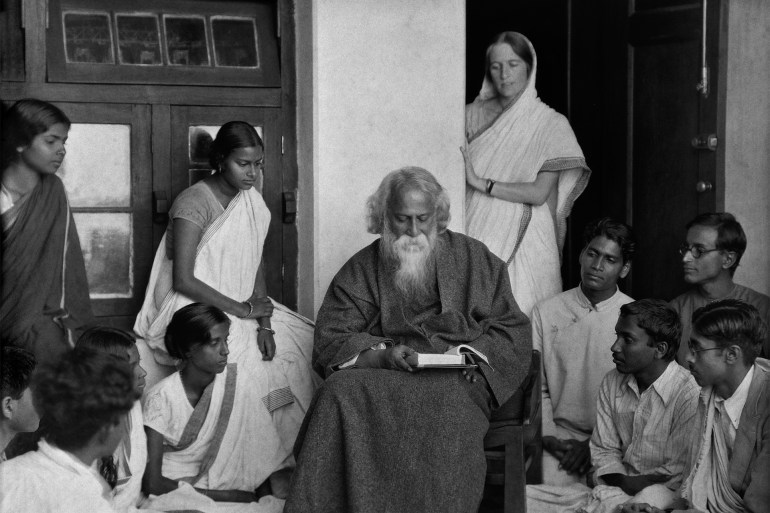 Students surround writer Rabindranath Tagore (1861 - 1941) at his university, Visva Bharati, in Santineketan, West Bengal, India, 1929. (Photo by E. O. Hoppe/Getty Images)