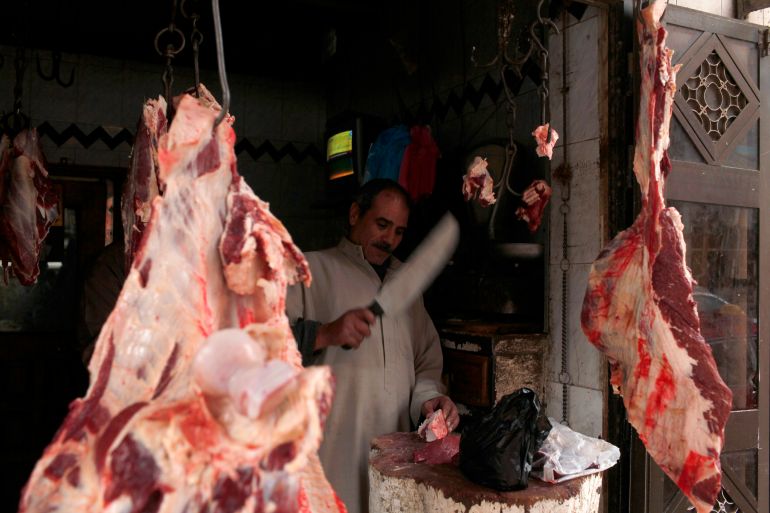 A butcher slices meat at his shop in the Egyptian Delta town of Zagazig January 7, 2013. Egypt's economy, once strong and popular among investors, has been in tatters since the revolt of 2011 that ousted Hosni Mubarak and shook the country to its foundations. As in other parts of Egypt, people in Zagazig see complex economic trends in terms of the daily hardships they must endure, and it is President Mohamed Mursi's government and his Muslim Brotherhood allies who get the blame. Picture taken January 7, 2013. To match story EGYPT-REGIONS/ REUTERS/Asmaa Waguih (EGYPT - Tags: BUSINESS POLITICS SOCIETY)