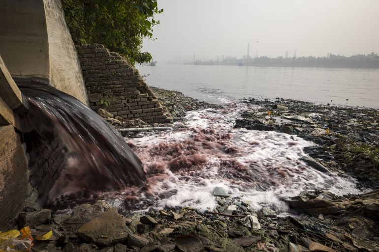 DHAKA, BANGLADESH - JANUARY 31: Wastewater containing fabric dye is released into streams and rivers by Textile Industries in Dhaka, Bangladesh on January 31, 2023. This dyed purple/red water flows from factories into the Buriganga River. (Photo by Zakir Hossain Chowdhury/Anadolu Agency via Getty Images)