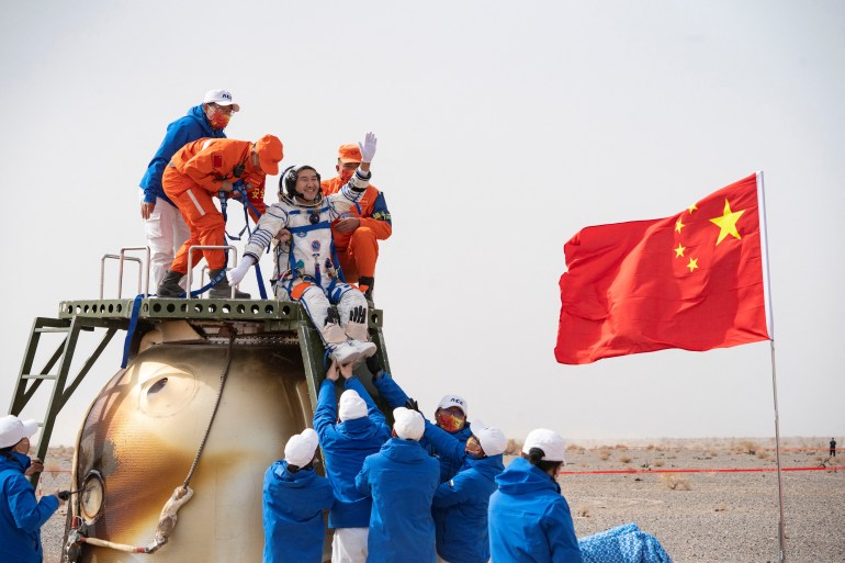 Rescue workers carry Chinese astronaut Zhai Zhigang out of a return capsule after astronauts return to earth following the Shenzhou-13 manned space mission