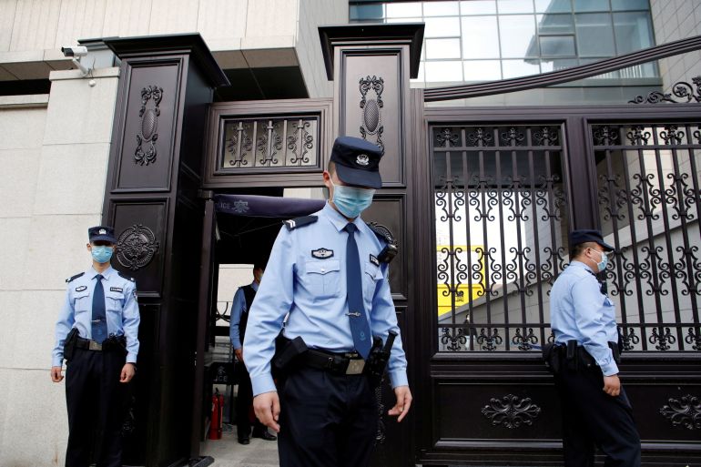Police officers outside a court in Beijing