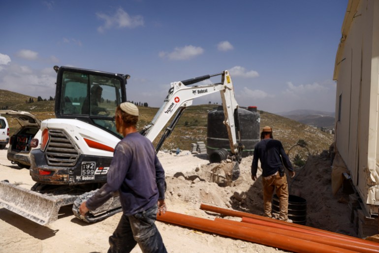 Israeli settlers erect a structure for a new Jewish seminary school, in the settler outpost of Homesh in the Israeli-occupied West Bank