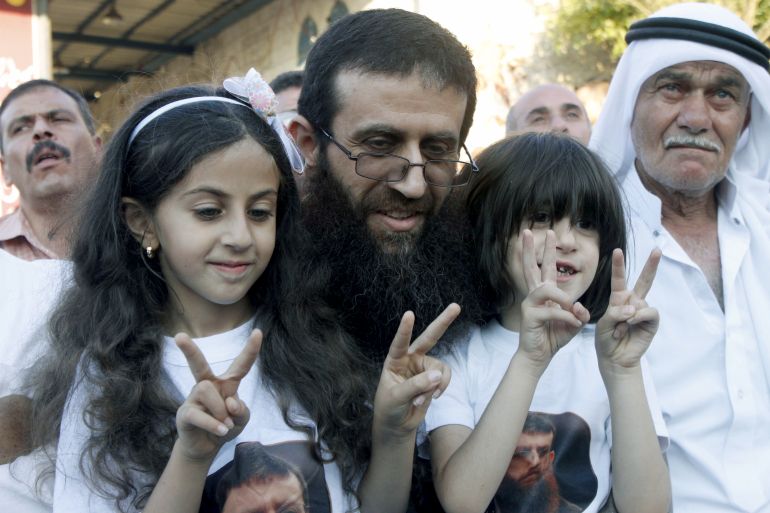 Palestinian Islamic Jihad leader Khader Adnan poses with his daughters during a rally honoring him following his release, near the West Bank city of Jenin