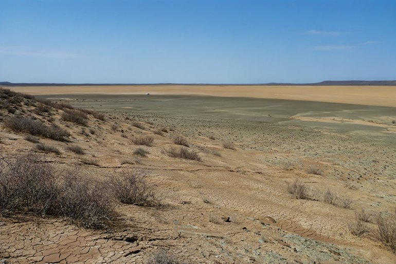 View across a now-dry lakebed near Swartkolkvloer. During the last glacial period this and adjacent basin supported what are believed to have been perennial lakes, some up to 60 feet in depth. CREDIT Brian Chase USAGE RESTRICTIONS Use only with credit. LICENSE Original content