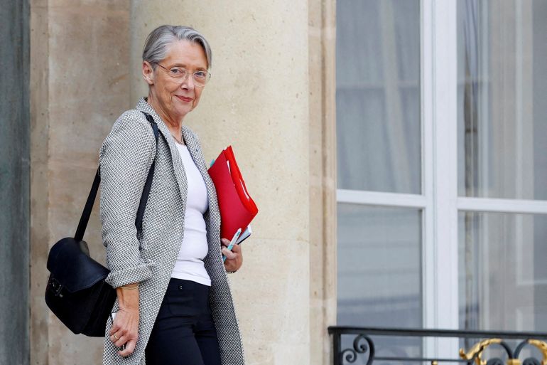 FILE PHOTO: French Prime Minister Elisabeth Borne leaves following a meeting with French President Emmanuel Macron, the leaders of the French Employers' association (MEDEF), the CPME and the Union of local businesses, after he signed into law the pension reform raising the retirement age, at the Elysee Palace in Paris, France, April 18, 2023. REUTERS/Stephanie Lecocq/File Photo