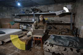 DONBAS, UKRAINE - FEBRUARY 20: Ukrainian frontline paramedic "Kava" uses a Starlink internet connection in a basement living quarters as Russian shells nearby above ground on February 20, 2023 in the Donbas region of eastern Ukraine. She and fellow paramedics, volunteering for Hospitallers, live in hidden locations close to the fighting, providing additional manpower and resources for evacuations to the military, which is often stretched thin. Hospitallers is a Ukrainian voluntary organization of doctors and paramedics who treat and evacuate soldiers from the battlefield. The group has more than 500 volunteers who work in two-week shifts as emergency responders. The organization relies on donations, both domestic and international, to fund the vast operation, including purchasing medical supplies and supporting the logistical needs of staff operating 32 ambulances and 76 pickup trucks, most in the war-torn Donbas region of eastern Ukraine. The volunteer paramedics come from a wide array of professions prior to joining Hospitallers and going through medical training. All are driven by the need to help in the war effort and relieve suffering of wounded Ukrainian soldiers. "Kava" which means coffee in Ukrainian, previously owned a coffee shop in Severodonetsk, which now is in Russian occupied Ukraine. (Photo by John Moore/Getty Images)