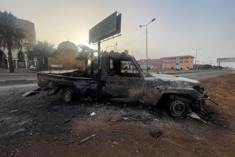 FILE PHOTO: A burned vehicle is seen in Khartoum