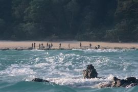 The Sentinelese stand guard on an island beach . Pic: © Christian Caron – Creative Commons A-NC-SA