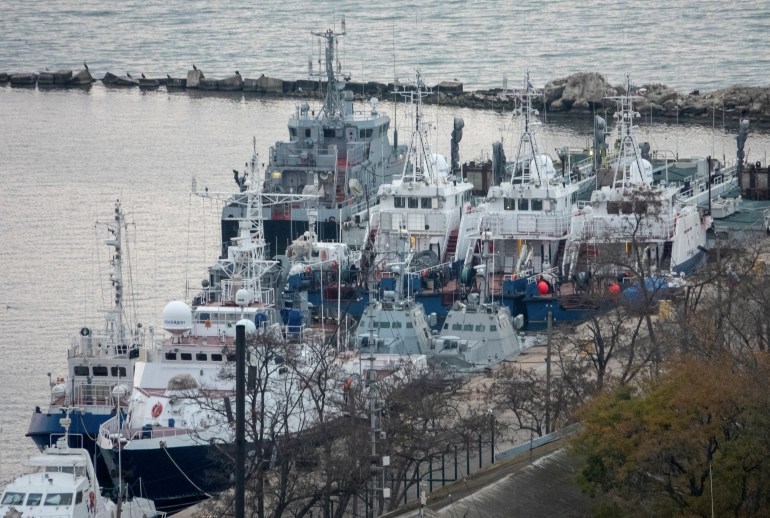 Seized Ukrainian naval ships are guarded by Russia's Coast Guard vessels in the port in Kerch, near the bridge connecting the Russian mainland with the Crimean Peninsula, Crimea November 17, 2019. REUTERS/Alla Dmitrieva