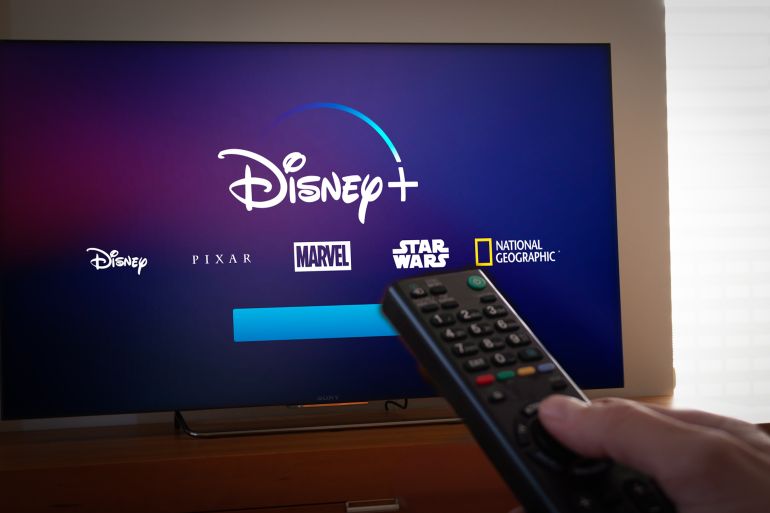 Barcelona, Spain. Jan 2019: Man holds a remote control With the new Disney+ screen on TV. Disney+ is an online video streaming subscription service.Illustrative