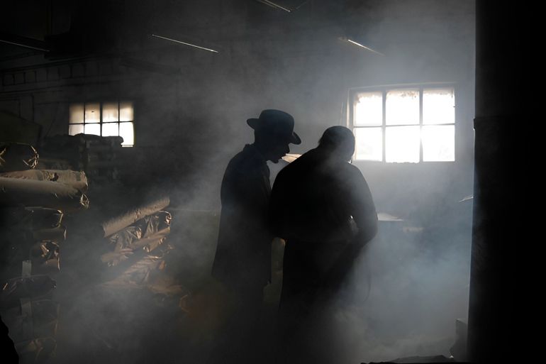 Silhouette of Men in Smoke - stock photo