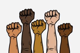 A group of multi-ethnics of hands fist including Afro American raising up together to symbolize equality and diversity of race and ethnicity. Isolated on white background.