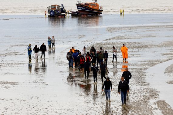 Dungeness, Kent, UK, 29th August 2022, migrants arrive on Dungeness beach after being rescued at sea by a lifeboat.