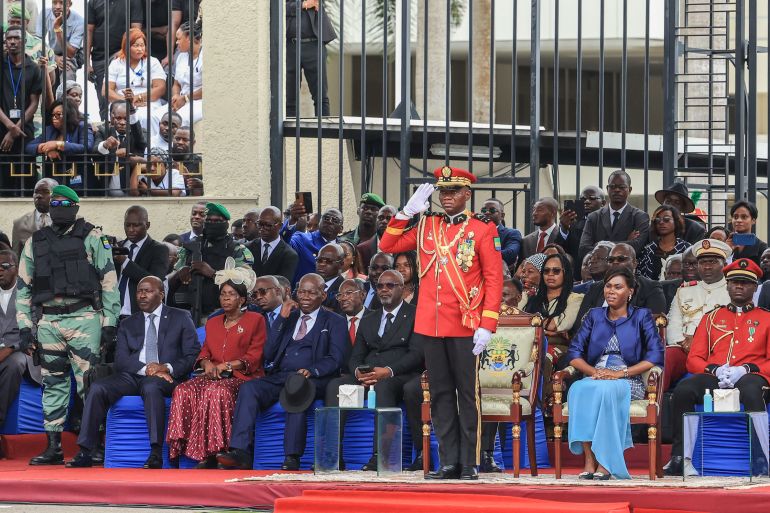 General Brice Oligui Nguema (C), who was inaugurated as Gabon's interim President, gives a salute during the military parade in Libreville on September 4, 2023. - Gabon's coup leader vowed after being sworn in as interim president on September 4, 2023 to restore civilian rule through "free, transparent and credible elections" after a transition and amnesty prisoners of conscience. (Photo by - / AFP) / ALTERNATE CROP - ALTERNATE CROP
