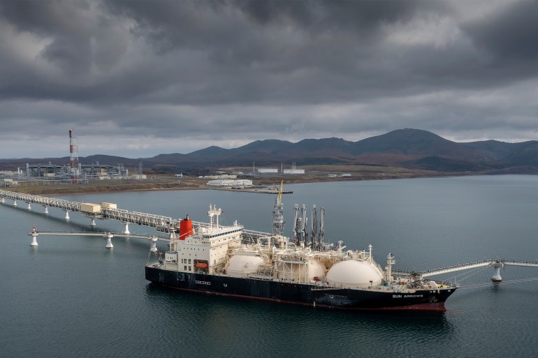 FILE - The tanker Sun Arrows loads its cargo of liquefied natural gas from the Sakhalin-2 project in the port of Prigorodnoye, Russia, on Oct. 29, 2021. After a year of far-reaching sanctions aimed at degrading Moscow's war chest, economic life for ordinary Russians doesn't look all that different than it did before the invasion of Ukraine. But with restrictions finally tightening on the Kremlin's chief moneymaker — oil — the months ahead will be an even tougher test of President Vladimir Putin's fortress economy. (AP Photo, File)
