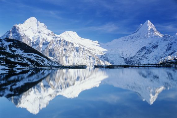 Switzerland, Swiss Alps, mountains reflected in lake water - stock photo