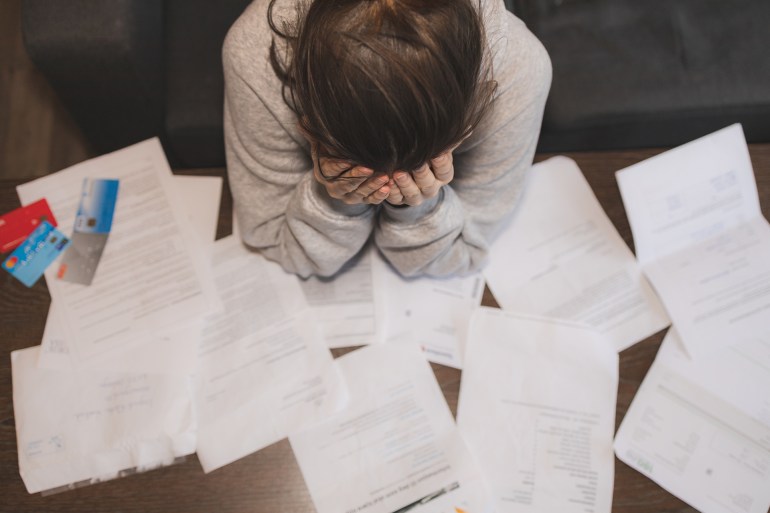 Shocked stressed young woman reading document letter from bank about loan debt financial problem, frustrated worried about bills notification, troubled with bad news or failed test results in mail; Shutterstock ID 1639896217; purchase_order:Interactive; job:shabakat; client:; other: