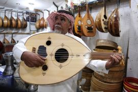 A Saudi musician plays at the oud instrument in a musical instruments shop at the Hilla market, in Riyadh, Saudi Arabia January 20, 2020. Picture taken January 20, 2020. REUTERS /Ahmed Yosri