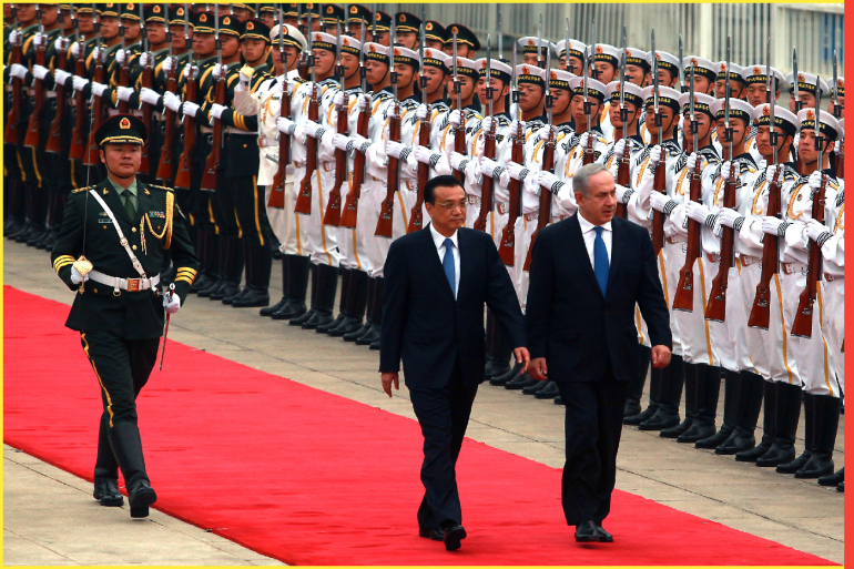 Israeli Prime Minister Benjamin Netanyahu (R) and Chinese Premier Li Keqiang attend a welcoming ceremony at the Great Hall of the People in Beijing on May 8, 2013. China is hosting the leaders of Palestine and Israel this week in a sign of its desire for a larger role in the Middle East peace process. China said it is willing to set up a meeting between the two countries, which have been deadlocked in talks for four years.