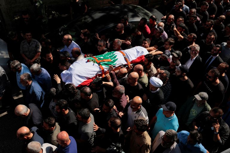 Mourners carry the body of Issam Abdallah, a Lebanese national and Reuters videojournalist who was killed in southern Lebanon by shelling from the direction of Israel, during his funeral in his home town of Al Khiyam, Lebanon October 14, 2023. REUTERS/Zohra Bensemra