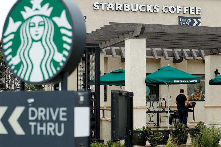 A worker puts away patio furniture at a Starbucks Corp drive-through location closes down this afternoon for anti-bias training as the coffee chain closed all 8,000 of their company-owned cafes in the U.S. including this location in Oceanside, California, U,S. May 29, 2018. REUTERS/Mike Blake