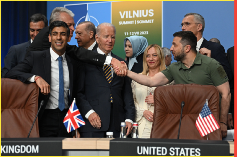 VILNIUS, LITHUANIA - JULY 12: Ukraine's President Volodymyr Zelensky (R) shakes hands with Lithuania's President Gitanas Nauseda (2nd L) next to (L-R) Spain's Prime Minister Pedro Sanchez, Turkey's President Recep Tayyip Erdogan, US President Joe Biden Italy's Prime Minister Giorgia Meloni and NATO Secretary General Jens Stoltenberg at a meeting of the NATO-Ukraine Council during the NATO Summit on July 12, 2023 in Vilnius, Lithuania. The summit is bringing together NATO members and partner countries heads of state from July 11-12 to chart the alliance's future, with Sweden's application for membership and Russia's ongoing war in Ukraine as major topics on the summit agenda. (Photo by Paul Ellis - Pool/Getty Images)