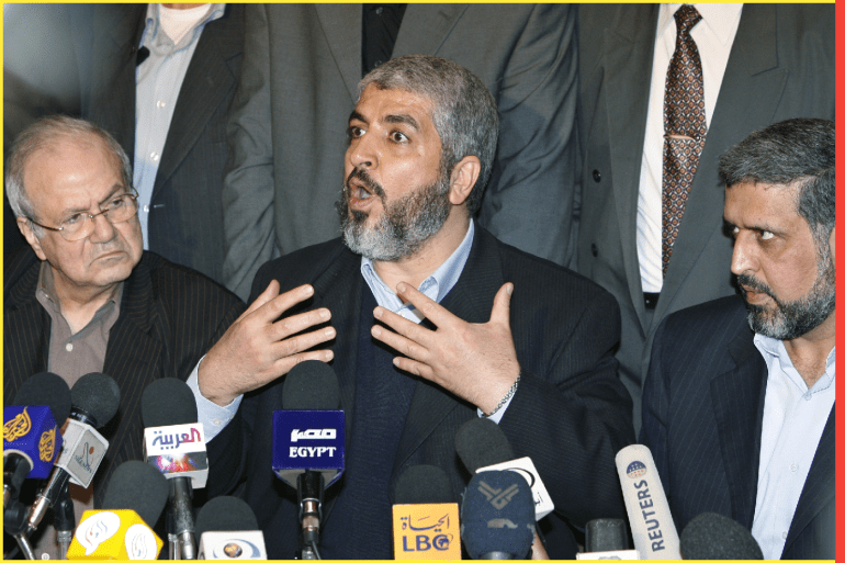Hamas leader Khaled Meshaal (C) speaks during a news conference with the other Palestinian factions in Damascus December 16, 2006. Flanking Khaled is, Ramadan Shallah (R), head of the militant Palestinan Islamic Jihad group and Farouk Kaddoumi, head of the political department of the Palestinian Liberation Organization (PLO). REUTERS/Khaled al-Hariri (SYRIA)