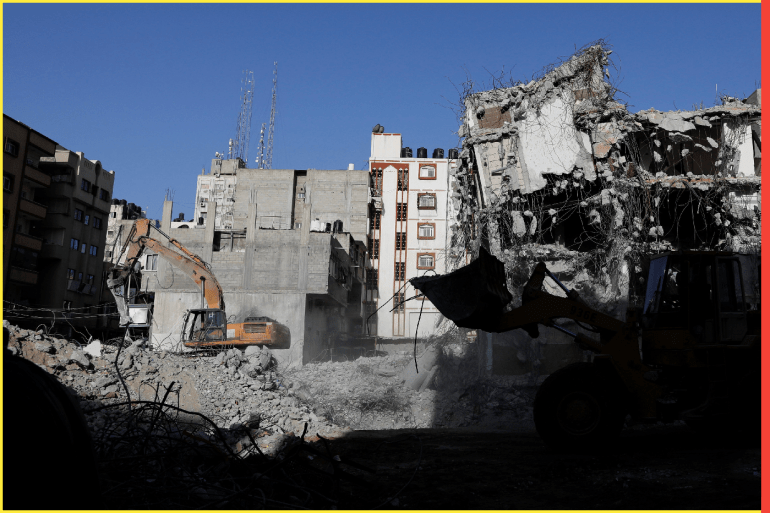 Bulldozers remove the debris from Al-Jawharah Tower building that was hit by Israeli air strikes during the Israeli-Palestinian conflict in May last year, in Gaza City, January 10, 2022. Picture taken January 10, 2022. REUTERS/Suhaib Salem