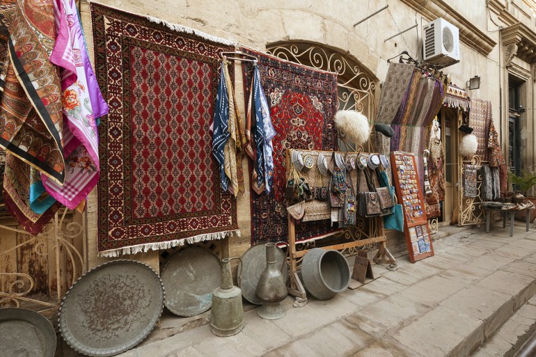 Azerbaijan, Baku, old city (Icari Seher), Market Square street scene with carpet-souvenir shop