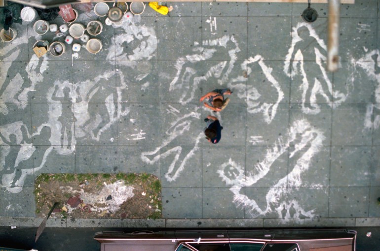 (Original Caption) Washington: Local citizens walk past "death shadows" painted on the sidewalk August 6th. Peace activists around the country painted similar silhouettes to mark the 40th anniversary of the atomic bombing of Hiroshima. The "shadows" represent those left behind by victims who were vaporized by the 1945 Hiroshima blast.