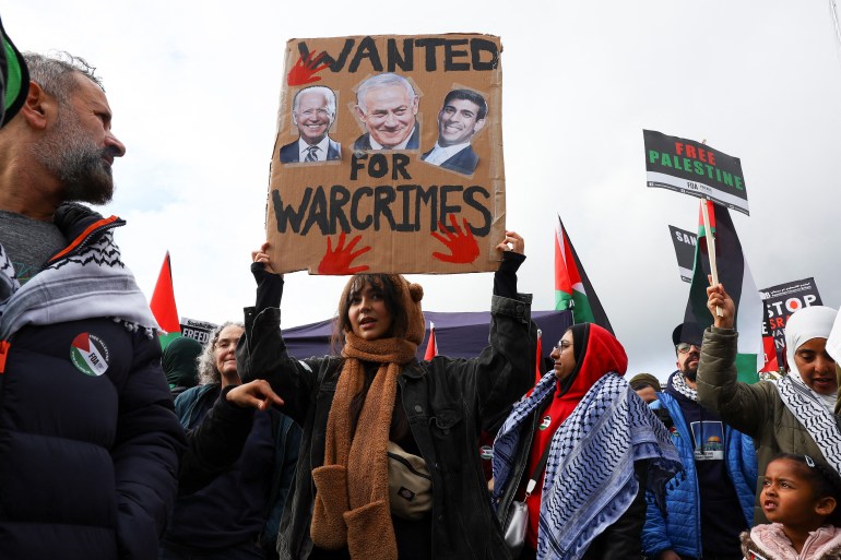 متظاهرون في لندن ضد العدوان الإسرائيلي على غزة يحملون لافتة تتهم بايدن وسوناك بأنهما شريكان في الجريمة إلى جانب نتنياهو (رويترز)
