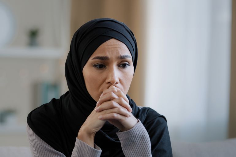 Upset sad girl in hijab sit alone get bad news feel depressed frustrated muslim woman suffering from illness worried about unresolved problems feeling sorrow grief hard divorce need psychological