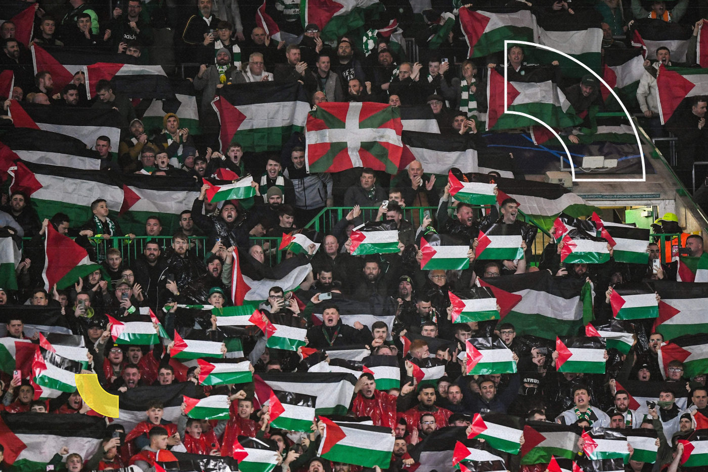 Supporters hold Palestinian flags as they cheer prior to the start of the UEFA Champions League group E football match between Celtic and Atletico Madrid at Celtic Park stadium in Glasgow, Scotland, on October 25, 2023. (Photo by ANDY BUCHANAN / AFP)