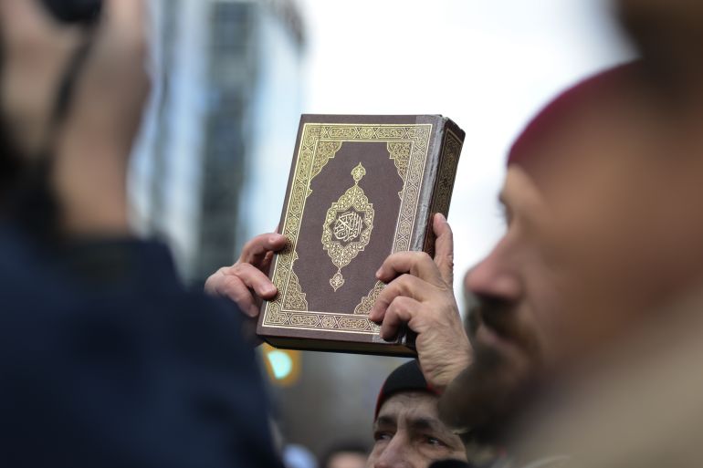 TORONTO-FEBRUARY 4:A Muslim man holding up the holy book of "quran" during a protest in front of the US Consulate to denounce Donald Trump's immigration policies on February 4,2017 in Toronto,Canada.