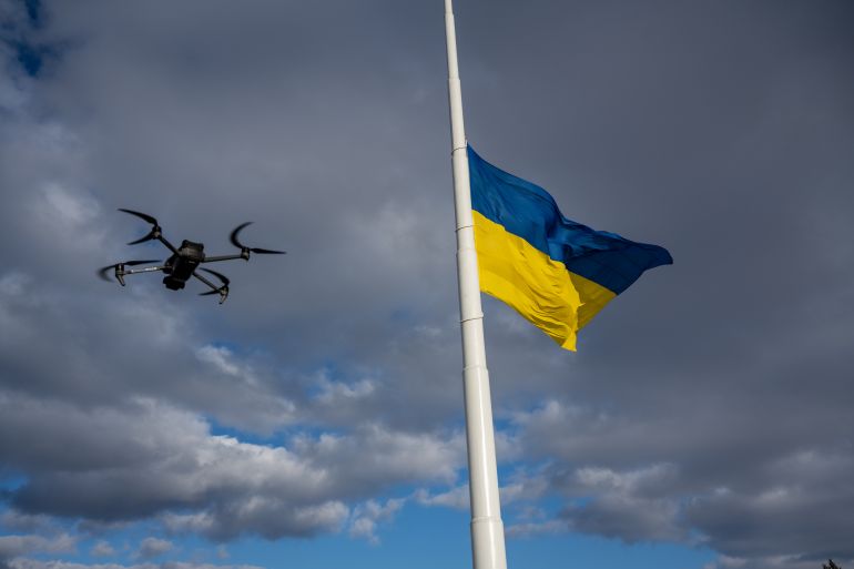 KRAMATORSK, UKRAINE - FEBRUARY 20: Ukrainian soldiers, who asked that their faces not be shown, practice piloting a commercial Mavic 3 drone in the sprawling central park - marked by a huge Ukrainian flag flying at half mast because of high winds - in the Donbas city of Kramatorsk, Ukraine, on February 20, 2023. Drones of all kinds have proven to be a critical tool used by the armed forces of both Ukraine and Russia, for reconnaisance, damage assessments, and to drop munitions and in kamikaze roles. (Photo by Scott Peterson/Getty Images)