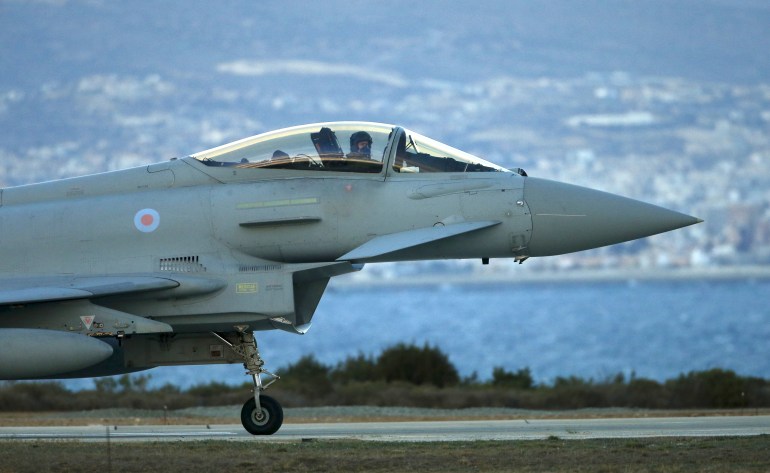 A pilot gestures from an RAF Typhoon plane as it taxis after landing at RAF Akrotiri in southern Cyprus December 3, 2015. REUTERS/Darren Staples