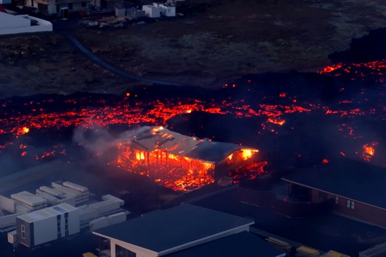 Lava flows from a volcano as houses burn in Grindavik, Iceland, January 14, 2024, in this screen grab obtained from a social media video. Bjorn Steinbekk/@bsteinbekk via Instagram/via REUTERS THIS IMAGE HAS BEEN SUPPLIED BY A THIRD PARTY. MANDATORY CREDIT. NO RESALES. NO ARCHIVES.
