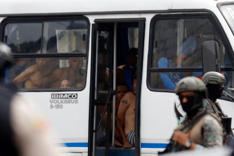 CORRECTION / Arrested men who attempted to take over a hospital sit in a police bus in Guayas, Ecuador, on January 21, 2024. Police in violence-plagued Ecuador arrested 68 people Sunday who had attempted to take over a hospital in the country's southwest in the midst of a "war" between drug gangs and the security forces. (Photo by STRINGER / AFP)