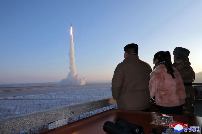 CORRECTION / TOPSHOT - This undated picture released by North Korea's official Korean Central News Agency (KCNA) on December 19, 2023 shows North Korean leader Kim Jong Un (L) and his daughter watching the test launch of a Hwasongpho-18 intercontinental ballistic missile (ICBM) at an undisclosed location in North Korea. North Korean leader Kim Jong Un personally oversaw this week's test launch of the country's most powerful solid-fuel intercontinental ballistic missile, which has the potential to reach the United States, state media said December 19. - - South Korea OUT / ---EDITORS NOTE--- RESTRICTED TO EDITORIAL USE - MANDATORY CREDIT "AFP PHOTO/KCNA VIA KNS" - NO MARKETING NO ADVERTISING CAMPAIGNS - DISTRIBUTED AS A SERVICE TO CLIENTS