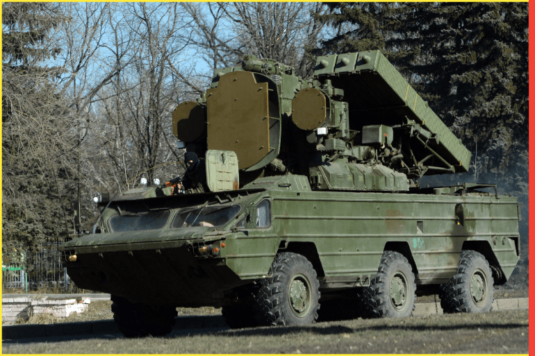 Pro-Russian separatist ride on the 9K33 Osa surface-to-air missile system (NATO reporting name is SA-8 Gecko) in the eastern Ukrainian city of Makeyevka on February 21, 2015. Ukraine's military and pro-Moscow rebels swapped scores of prisoners in rare compliance with a truce so badly breached over the past week that the US warned it could escalate sanctions on Russia within days. AFP PHOTO / VASILY MAXIMOV (Photo by VASILY MAXIMOV / AFP)