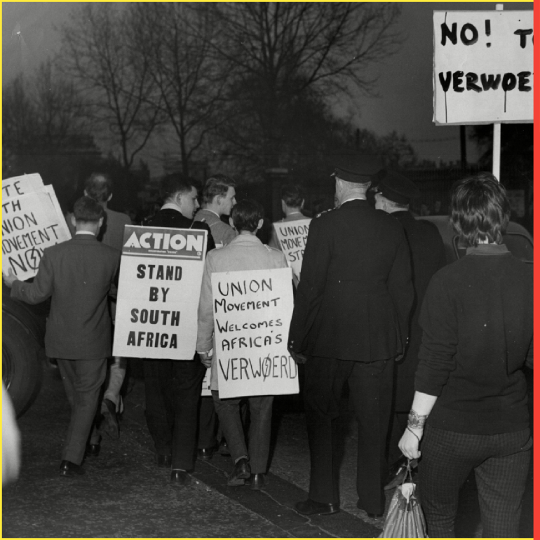 Verwoerd Demonstration Outside Dorchester. Police Protect An Anti-verwoerd Demonstrator From Members Of The British National Party. Hendrik Frensch Verwoerd (8 September 1901 ? 6 September 1966) Was Prime Minister Of South Africa From 1958 Until His Assassination In 1966. He Was Prime Minister During The Establishment Of The Republic Of South Africa In 1960 Thereby Fulfilling The Afrikaner Dream Of An Independent Republic For South Africans. During His Tenure As Prime Minister Anti-apartheid Movements Such As The African National Congress (anc) And Pan Africanist Congress Were Banned And The Rivonia Trial Which Prosecuted The Struggle's Leaders Was Held.