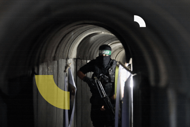 A member of the Ezzedine al-Qassam Brigades, the military wing of the Palestinian Islamist movement Hamas, walks inside a tunnel used for military exercises during a weapon exhibition at a Hamas-run youth summer camp
