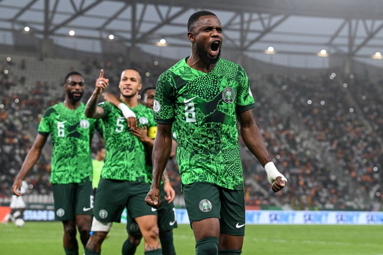 Nigeria's midfielder #8 Frank Onyeka (R) celebrates the team's first goal during the Africa Cup of Nations (CAN) 2024 semi-final football match between Nigeria and South Africa at the Stade de la Paix in Bouake on February 7, 2024. (Photo by Issouf SANOGO / AFP)