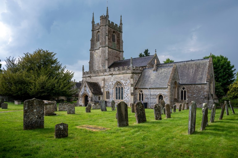 Avebury, Wiltshire, UK - june 10, 2023 : Avebury village church under stormy skies