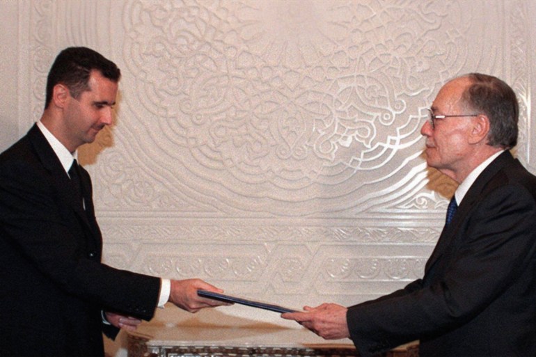Syrian Parliament Speaker Abdel-Qadar Qaddura (R) presents president-designate Bashar al-Assad with the parliament approval of Bashar's candidacy to succeed his late father Hafez al-Assad, 27 June 2000 in Damascus. Qaddura fixed July 10 as the date for a national plebiscite, the final stage in Bashar's rise to the top following his father Hafez al-Assad's death on 10 June. (Photo by SANA / AFP) (Photo by -/SANA/AFP via Getty Images)