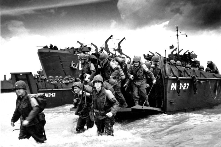 American reinforcements, arrive on the beaches of Normandy from a Coast Guard landing barge into the surf on the French coast on June 23, 1944 during World War II. They will reinforce fighting units that secured the Norman beachhead and spread north toward Cherbourg. (AP Photo/U.S. COAST GUARD)