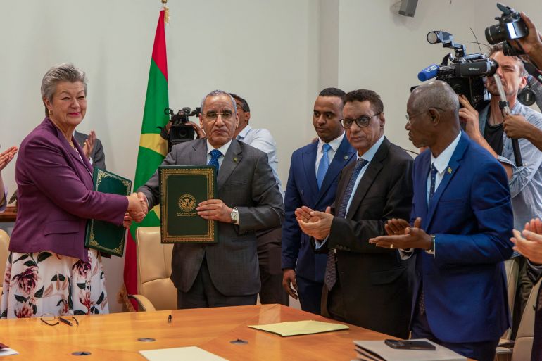 European Commissioner for Home Affairs Ylva Johansson (L) and the Mauritanian Minister of Interior Mohamed Ahmed Ould Mohamed Lemine (2nd R) signs a migration agreement at the Nouakchott Palace in Nouakchott on March 7, 2024. (Photo by Med LEMIN RAJEL / AFP)